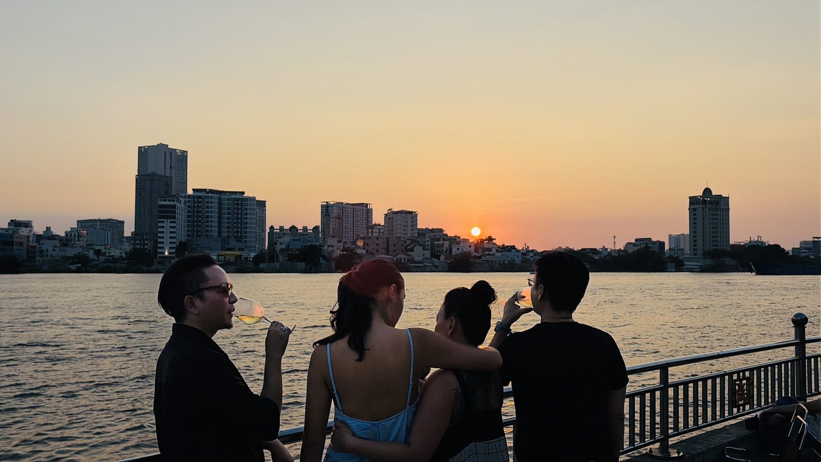 Guests watching the sunset over the Saigon River at Mia Saigon
